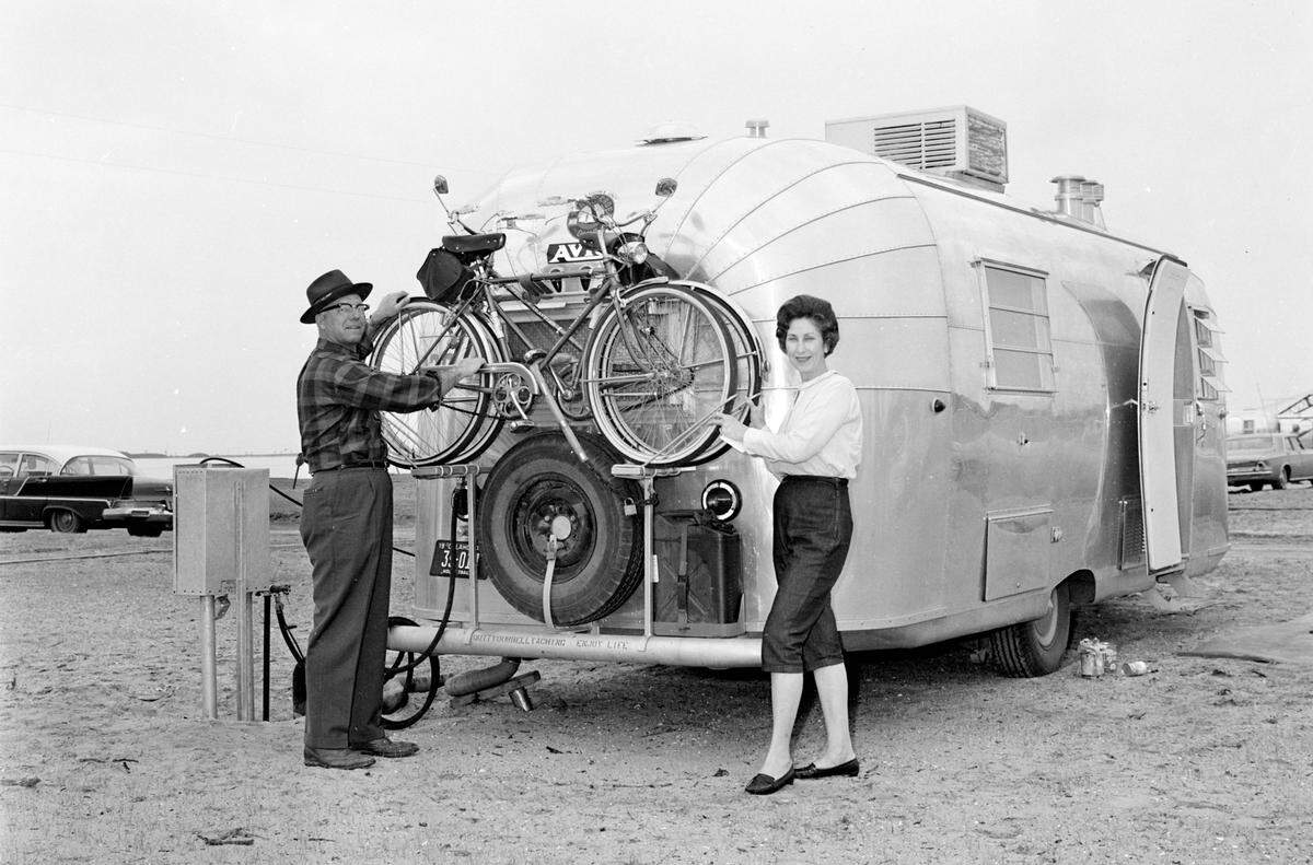 Airstream with bicycle rack at hitch, circa 1960s — the question hiding in plain sight