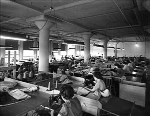 Eddie Bauer factory floor wartime production — rows of women workers at sewing machines producing flight suits and sleeping bags