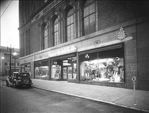 Eddie Bauer store on Second Avenue Seattle at night, circa late 1930s, Christmas window display, automobile parked outside