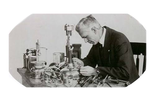 W.C. Coleman at his workbench with lantern components, circa 1900s
